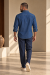 Back view of ARTLESS The Western Edit indigo cotton denim shirt showing the shoulder yoke and curved hem.