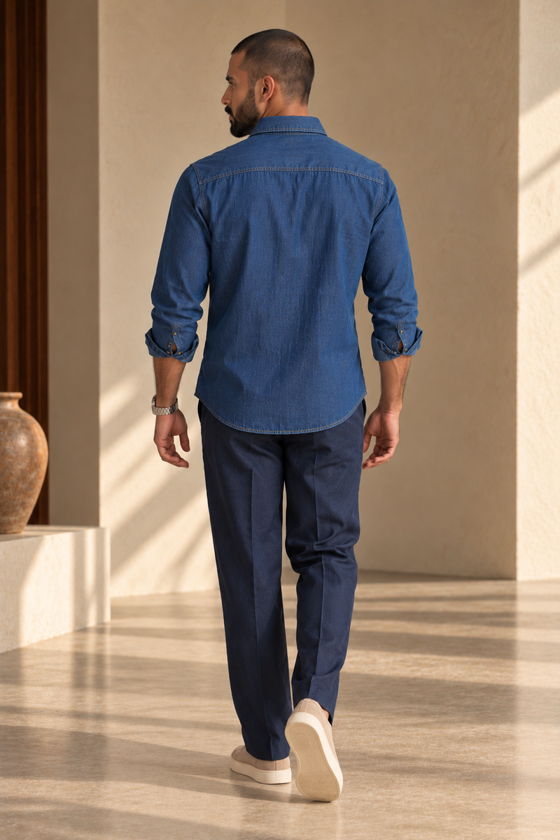 Back view of ARTLESS The Western Edit indigo cotton denim shirt showing the shoulder yoke and curved hem.