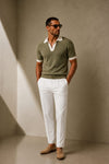 ARTLESS Riviera Polo in olive sage with contrasting ivory collar and cuffs, styled with white tailored trousers.