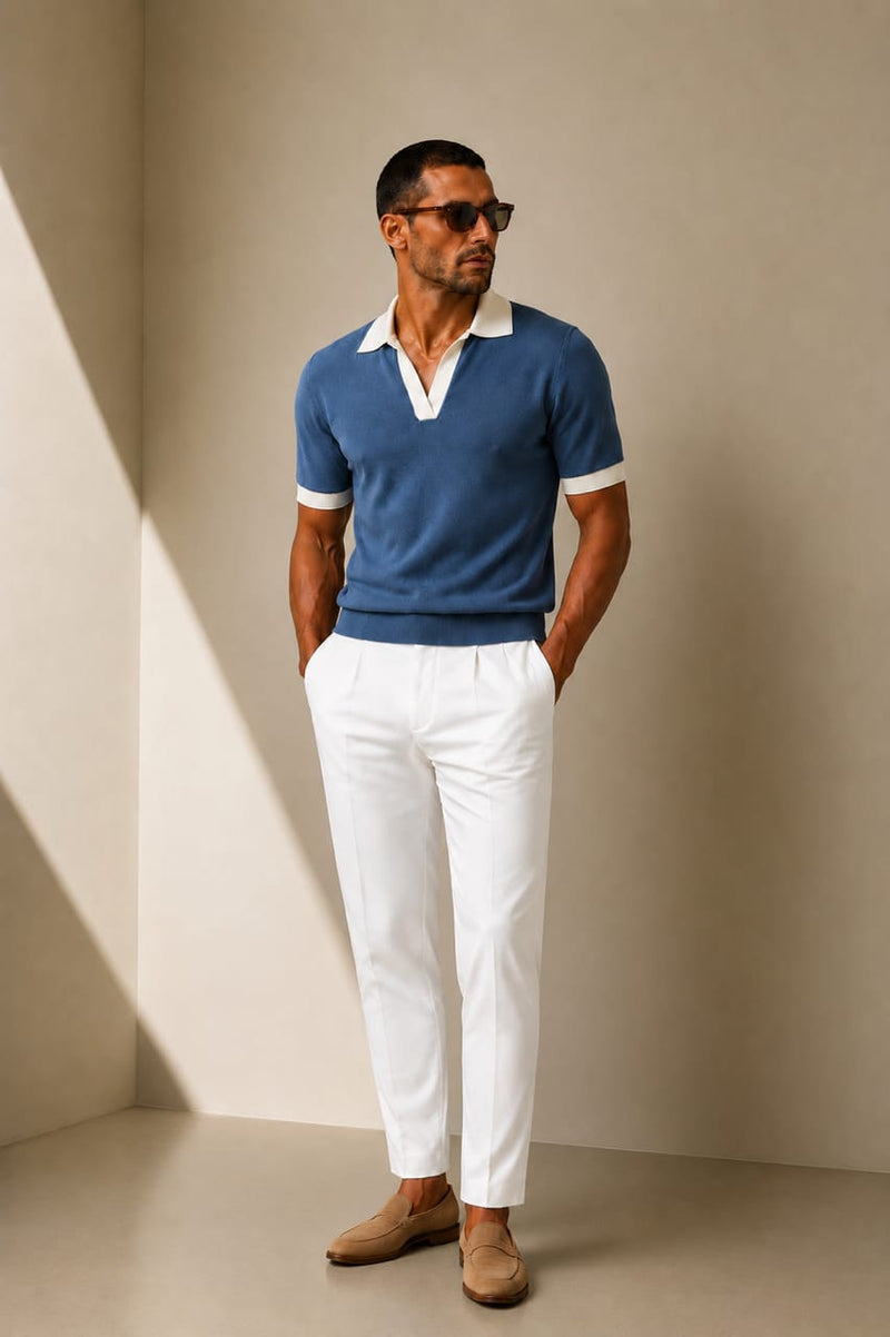 ARTLESS Riviera Polo in muted blue with ivory contrast collar and sleeve cuffs, styled with white trousers.