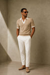 ARTLESS Riviera Polo in sand beige featuring an open V-neck, ivory collar and matching sleeve cuffs.